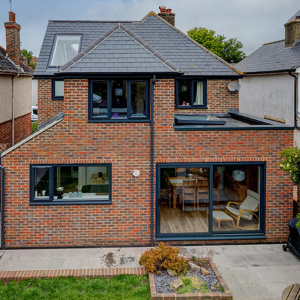 Stock roof windows help to floor this modern extension with natural light